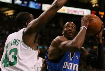 BOSTON - MAY 12:  Dwight Howard #12 of the Orlando Magic drives to the net as Kendrick Perkins #43 of the Boston Celtics defends in Game Five of the Eastern Conference Semifinals during the 2009 NBA Playoffs at TD Banknorth Garden May 12, 2009 in Boston, Massachusetts. The Celtics defeated the Magic 92-88.  NOTE TO USER: User expressly acknowledges and agrees that, by downloading and or using this photograph, User is consenting to the terms and conditions of the Getty Images License Agreement.  (Photo by Elsa/Getty Images)