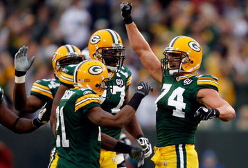 GREEN BAY, WI - SEPTEMBER 08:  (R) Aaron Kampman#74 of the Green Bay Packers reacts with teammates after sacking quarterback Tarvaris Jackson #7 of the Minnesota Vikings in the first quarter on September 8, 2008 at Lambeau Field in Green Bay, Wisconsin.  (Photo by Dilip Vishwanat/Getty Images)
