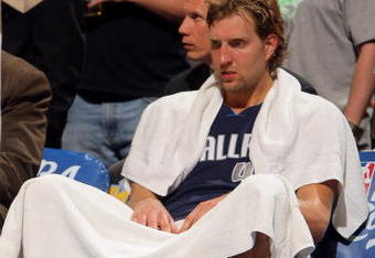 DENVER - MAY 13:  Dirk Nowitzki #41 of the Dallas Mavericks sits on the bench late in the game against  the Denver Nuggets in Game Five of the Western Conference Semifinals during the 2009 NBA Playoffs at Pepsi Center on May 13, 2009 in Denver, Colorado. The Nuggets defeated the Mavericks 124-110 to advance to the Western Conference Finals. NOTE TO USER: User expressly acknowledges and agrees that, by downloading and or using this photograph, User is consenting to the terms and conditions of the Getty Images License Agreement.  (Photo by Doug Pensinger/Getty Images)