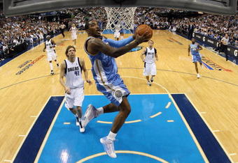 DALLAS - MAY 11:  Guard J.R. Smith #1 of the Denver Nuggets takes a shot against Dirk Nowitzki #41 of the Dallas Mavericks in Game Four of the Western Conference Semifinals during the 2009 NBA Playoffs at American Airlines Center on May 11, 2009 in Dallas, Texas. NOTE TO USER: User expressly acknowledges and agrees that, by downloading and or using this photograph, User is consenting to the terms and conditions of the Getty Images License Agreement.  (Photo by Ronald Martinez/Getty Images)