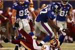 EAST RUTHERFORD, NJ - SEPTEMBER 04:  Brandon Jacobs #27 of the New York Giants runs through the tackle of LaRon Landry #30 of the Washington Redskins at Giants Stadium on September 4, 2008 in East Rutherford, New Jersey  (Photo by Al Bello/Getty Images)