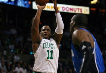 BOSTON - MAY 12:  Glen Davis #11 of the Boston Celtics takes a shot as Dwight Howard #12 of the Orlando Magic defends in Game Five of the Eastern Conference Semifinals during the 2009 NBA Playoffs at TD Banknorth Garden May 12, 2009 in Boston, Massachusetts.  NOTE TO USER: User expressly acknowledges and agrees that, by downloading and or using this photograph, User is consenting to the terms and conditions of the Getty Images License Agreement.  (Photo by Elsa/Getty Images)