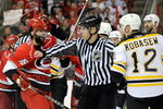 RALEIGH, NC - MAY 12:  An official separates Ryan Bayda #18 of the Carolina Hurricanes and Chuck Kobasew #12 of the Boston Bruins as they fight during Game Six of the Eastern Conference Semifinal Round of the 2009 Stanley Cup Playoffs on May 12, 2009 at the RBC Center in Raleigh, North Carolina. (Photo by Grant Halverson/Getty Images)