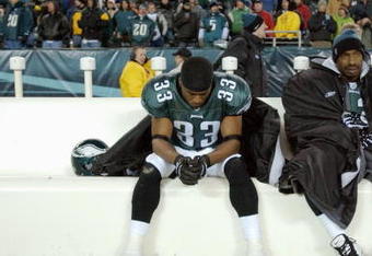 PHILADELPHIA - JANUARY 18:  Free safety Clinton Hart #33 of the Philadelphia Eagles sits next to wide receiver Greg Lewis #83 during the NFC Championship game against the Carolina Panthers at Lincoln Financial Field on January 18, 2004 in Philadelphia, Pennsylvania.  The Panthers defeated the Eagles 14-3.  (Photo by Doug Pensinger/Getty Images)  