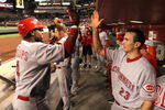 PHOENIX - MAY 12:  Brandon Phillips #4 of the Cincinnati Reds is congratulated by teammate Adam Rosales #23 in the dugout after Phillips hit a solo home run against the Arizona Diamondbacks during the sixth inning of the major league baseball game at Chase Field on May 12, 2009 in Phoenix, Arizona.  (Photo by Christian Petersen/Getty Images)