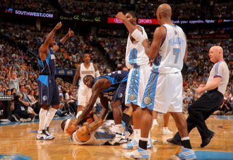DENVER - MAY 13:  Kenyon Martin #4 of the Denver Nuggets and Brandon Bass #32 of the Dallas Mavericks end up with a jump ball call in Game Five of the Western Conference Semifinals during the 2009 NBA Playoffs at Pepsi Center on May 13, 2009 in Denver, Colorado. The Nuggets defeated the Mavericks 124-110 to advance to the Western Conference Finals. NOTE TO USER: User expressly acknowledges and agrees that, by downloading and or using this photograph, User is consenting to the terms and conditions of the Getty Images License Agreement.  (Photo by Doug Pensinger/Getty Images)