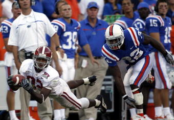 GAINESVILLE, FL - SEPTEMBER 30:  Alabama Crimson wide receiver Earl Alexander #82 tries  to catch the ball as Florida Gators defensive back Reggie Lewis #22 looks on September 30, 2006 at Ben Hill Griffin Stadium at Florida Field  in Gainsville, Florida.  (Photo by Marc Serota/Getty Images)