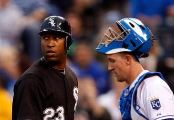 KANSAS CITY, MO - MAY 05:  Jermaine Dye #23 of the Chicago White Sox watches the replay on the scoreboard after hitting a two-run home run as catcher John Buck #14 looks on during the third inning against the Kansas City Royals on May 5, 2009 at Kauffman Stadium in Kansas City, Missouri.  (Photo by Jamie Squire/Getty Images)
