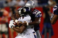 FOXBORO, MA - AUGUST 7: Ray Rice #39 of the Baltimore Ravens has his helmet knocked off as he is tackled by Jerod Mayo #51 of the New England Patriots during the preseason game at Gillette Stadium on August 7, 2008 in Foxboro, Massachusetts. (Photo by Jim Rogash/Getty Images)