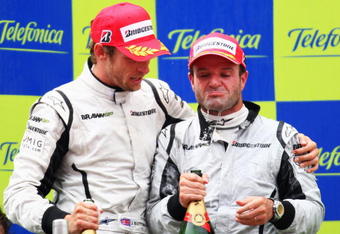 BARCELONA, SPAIN - MAY 10:  First placed Jenson Button (L) of Great Britain and Brawn GP and second placed Rubens Barrichello (R) of Brazil and Brawn GP are seen on the podium following the Spanish Formula One Grand Prix at the Circuit de Catalunya on May 10, 2009 in Barcelona, Spain.  (Photo by Clive Mason/Getty Images)