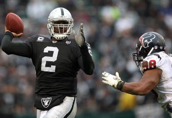 OAKLAND, CA - DECEMBER 21: JaMarcus Russell #2 of the Oakland Raiders passes against Anthony Weaver #98 of the Houston Texans during an NFL game on December 21, 2008 at the Oakland-Alameda County Coliseum in Oakland, California.  (Photo by Jed Jacobsohn/Getty Images)