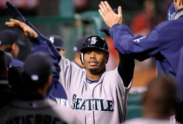 ANAHEIM, CA - APRIL 25:  Ken Griffey Jr. #24 of the Seattle Mariners is congratulated in the dugout after scoring on a base hit by Russell Branyan #30 against the Los Angeles Angels of Anaheim during the seventh inning of the baseball game on April 25, 2009 at Angel Stadium in Anaheim, California.  (Photo by Kevork Djansezians/Getty Images)