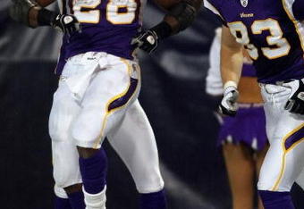 MINNEAPOLIS - JANUARY 4:  Adrian Peterson #28 of the Minnesota Vikings celebrates his touchdown with teammate Jeff Dugan #83 in the first half against the Philadelphia Eagles during the NFC Wild Card playoff game on January 4, 2009 at the Hubert H. Humphrey Metrodome in Minneapolis, Minnesota. (Photo by Elsa/Getty Images)