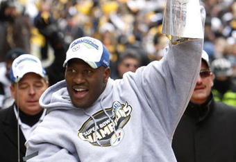 PITTSBURGH - FEBRUARY 03:  James Harrison #92 of the Pittsburgh Steelers shows off the Super Bowl XLIII trophy during a parade on February 3, 2009 in Pittsburgh, Pennsylvania.  (Photo by Gregory Shamus/Getty Images)