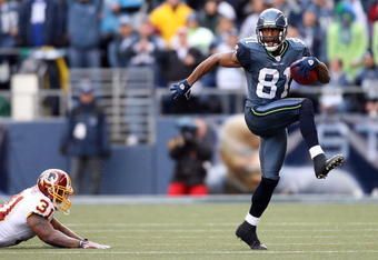 SEATTLE - JANUARY 05:  Wide receiver Nate Burleson #81 of the Seattle Seahawks high steps away from Rock Cartwright #31 of the Washington Redskins during a punt return in the first quarter of the NFC Wild Card game at Qwest Field on January 5, 2008 in Seattle, Washington.  (Photo by Otto Greule Jr/Getty Images)