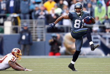 SEATTLE - JANUARY 05:  Wide receiver Nate Burleson #81 of the Seattle Seahawks high steps away from Rock Cartwright #31 of the Washington Redskins during a punt return in the first quarter of the NFC Wild Card game at Qwest Field on January 5, 2008 in Seattle, Washington.  (Photo by Otto Greule Jr/Getty Images)