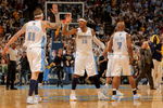 DENVER - MAY 03:  Chris Andersen #11, Carmelo Anthony #15 and Chauncey Billups #7 of the Denver Nuggets celebrate during a time out against the Dallas Mavericks in Game One of the Western Conference Semifinals during the 2009 NBA Playoffs at Pepsi Center on May 3, 2009 in Denver, Colorado. The Nuggets defeated the Mavericks 109-95. NOTE TO USER: User expressly acknowledges and agrees that, by downloading and or using this photograph, User is consenting to the terms and conditions of the Getty Images License Agreement.  (Photo by Doug Pensinger/Getty Images)
