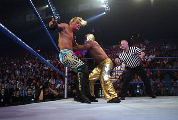 LAS VEGAS - DECEMBER 2:  (U.S. TABLOIDS OUT)   WWE wrestlers Rey Mysterio (in gold) and Chris Jericho perform on stage during the '1st Annual Video Game Awards' at the MGM Grand Garden Arena December 2, 2003 in Las Vegas, Nevada.  The show premieres on Spike T.V. Thursday, December 4 at 9:00PM ET/PT.  (Photo by Frank Micelotta/Getty Images)