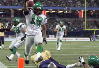 TORONTO - NOVEMBER 25:  James Johnson #19 of the Saskatchewan Rough Riders jumps over a fallen Ryan Dinwiddie #4 after his interception to score a touchdown to tie the game 7-7 against the Winnipeg Blue Bombers during the second quarter of the 95th Grey Cup on November 25, 2007 at the Rogers Centre in Toronto, Ontario, Canada.  Johnson would be the MVP in a 23-19 Rough Rider win.  (Photo by Harry How/Getty Images)