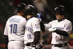 CLEVELAND - APRIL 10: Marco Scutaro #19 of the Toronto Blue Jays celebrates with Aaron Hill  #2 and  Vernon Wells #10 after scoring against the Cleveland Indians in the seventh inning April 10, 2009 at Progressive Field in Cleveland, Ohio.  (Photo by Matt Sullivan/Getty Images)