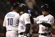 CLEVELAND - APRIL 10: Marco Scutaro #19 of the Toronto Blue Jays celebrates with Aaron Hill  #2 and  Vernon Wells #10 after scoring against the Cleveland Indians in the seventh inning April 10, 2009 at Progressive Field in Cleveland, Ohio.  (Photo by Matt Sullivan/Getty Images)