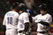 CLEVELAND - APRIL 10: Marco Scutaro #19 of the Toronto Blue Jays celebrates with Aaron Hill  #2 and  Vernon Wells #10 after scoring against the Cleveland Indians in the seventh inning April 10, 2009 at Progressive Field in Cleveland, Ohio.  (Photo by Matt Sullivan/Getty Images)