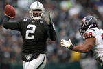 OAKLAND, CA - DECEMBER 21: JaMarcus Russell #2 of the Oakland Raiders passes against Anthony Weaver #98 of the Houston Texans during an NFL game on December 21, 2008 at the Oakland-Alameda County Coliseum in Oakland, California.  (Photo by Jed Jacobsohn/Getty Images)