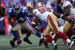 EAST RUTHERFORD, NJ - OCTOBER 19:  Ahmad Bradshaw #44 of the New York Giants pushes off a tackle from Manny Lawson #99 of the San Francisco 49ers on October 19, 2008 at Giant Stadium in East Rutherford, New Jersey. The Giants defeated the 49ers 27-19. (Photo by Chris Trotman/Getty Images)