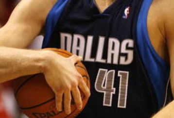 MIAMI - JANUARY 21:  Forward Dirk Nowitzki #41 of the Dallas Mavericks holds onto the ball after a rebound against the Miami Heat in the fourth period on January 21, 2007 at the American Airlines Arena in Miami  Florida.  NOTE TO USER: User expressly acknowledges and agrees that, by downloading and/or using this Photograph, User is consenting to the terms and conditions of the Getty Images License Agreement.  (Photo by Eliot J. Schechter/Getty Images)