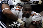 IRVING, TX - NOVEMBER 23:  Running back Frank Gore #21 of the San Francisco 49ers loses his helmet while tackled by Anthony Spencer #93 of the Dallas Cowboys at Texas Stadium on November 23, 2008 in Irving, Texas.  (Photo by Ronald Martinez/Getty Images)