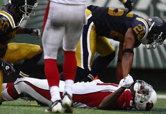 EAST RUTHERFORD, NJ - SEPTEMBER 28: Anquan Boldin #81 of the Arizona Cardinals lays on the field after colliding heavily with Eric Smith #33 of the New York Jets on September 28, 2008 at Giants Stadium in East Rutherford, New Jersey.  (Photo by Chris McGrath/Getty Images)