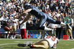 SEATTLE - SEPTEMBER 14:  Punter Jon Ryan #9 of the Seattle Seahawks tumbles over Manny Lawson #99 of the San Francisco 49ers after Lawson ran into Ryan on a blocked punt on September 14, 2008 at Qwest Field in Seattle Washington. The 49ers defeated the Seahawks 33-30 in overtime. (Photo by Otto Greule Jr/Getty Images)
