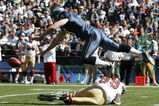 SEATTLE - SEPTEMBER 14:  Punter Jon Ryan #9 of the Seattle Seahawks tumbles over Manny Lawson #99 of the San Francisco 49ers after Lawson ran into Ryan on a blocked punt on September 14, 2008 at Qwest Field in Seattle Washington. The 49ers defeated the Seahawks 33-30 in overtime. (Photo by Otto Greule Jr/Getty Images)