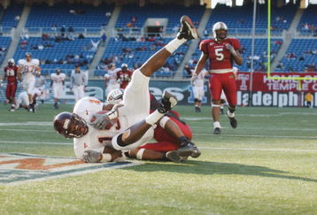 PHILADELPHIA - NOVEMBER 10:  Wide receiver Ernest Wilford #19 of the Virginia Tech Hokies makes a catch in front of cornerback Yazid Jackson #26 of the Temple Owls during the Big East Conference football game on November 10, 2001 at Veterans Stadium in Philadelphia, Pennsylvania. Virginia Tech defeated Temple 35-0 . (Photo by Doug Pensinger/Getty Images)