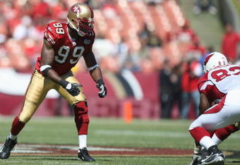 SAN FRANCISCO - SEPTEMBER 7:  Manny Lawson #99 of the San Francisco 49ers lines up during the game against the Arizona Cardinals on September 7, 2008 at Bill Walsh Field at Candlestick Park in San Francisco, California. (Photo by Jed Jacobsohn/Getty Images)