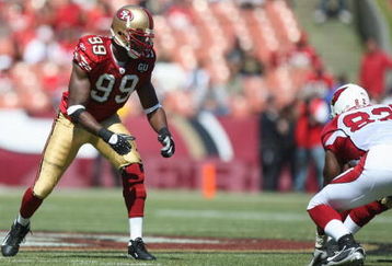SAN FRANCISCO - SEPTEMBER 7:  Manny Lawson #99 of the San Francisco 49ers lines up during the game against the Arizona Cardinals on September 7, 2008 at Bill Walsh Field at Candlestick Park in San Francisco, California. (Photo by Jed Jacobsohn/Getty Images)