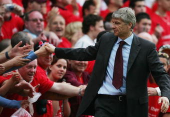 LONDON - MAY 07:  Arsene Wenger, the Arsenal manager, shakes hands with fans after the Barclays Premiership match between Arsenal and Wigan Athletic at Highbury on May 7, 2006 in London, England.  The match was the last to be played at Highbury after 93 years, as next season Arsenal will kick off nearby at the new Emirates Stadium.  (Photo by Shaun Botterill/Getty Images)