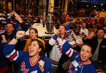 NEW YORK - APRIL 15:  Fans cheer on the New York Rangers during the first round of the playoffs against the Washington Capitals during the NHL Playoff Kickoff Party on April 15, 2009 at NHL Powered by Reebok Store in Manhattan. New York  (Photo by Mike Stobe/Getty Images for the NHL)