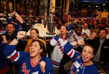 NEW YORK - APRIL 15:  Fans cheer on the New York Rangers during the first round of the playoffs against the Washington Capitals during the NHL Playoff Kickoff Party on April 15, 2009 at NHL Powered by Reebok Store in Manhattan. New York  (Photo by Mike Stobe/Getty Images for the NHL)