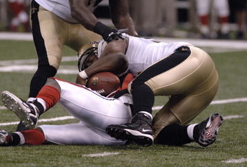 Atlanta Falcons quarterback Michael Vick is sacked by New Orleans Saints defensive end Will Smith   on  ESPN Monday Night Football September 25, 2006 in New Orleans. The Saints won 23 - 3.  (Photo by Al Messerschmidt/Getty Images)