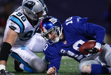 EAST RUTHERFORD, NJ - DECEMBER 21:  Quarterback Eli Manning #10 of the New York Giants gets sacked by Tyler Brayton #96 of the Carolina Panthers on December 21, 2008 at Giants Stadium in East Rutherford, New Jersey.  (Photo by Chris McGrath/Getty Images)