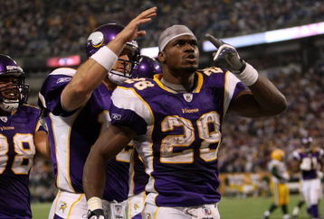 MINNEAPOLIS - NOVEMBER 09:  Running back Adrian Peterson #28 and quarterback Gus Frerotte #12 of the Minnesota Vikings celebrate after Peterson's game winning 29 yard touchdown run with 2:22 left in the game with the Green Bay Packers on November 9, 2008 at the Metrodome in Mineapolis, Minnesota.  (Photo by Stephen Dunn/Getty Images)