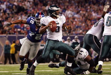 EAST RUTHERFORD, NJ - SEPTEMBER 30:  Donovan McNabb #5 of the Philadelphia Eagles gets sacked by Osi Umenyiora #72 of the New York Giants at Giants Stadium on September 30, 2007 in East Rutherford, New Jersey.  (Photo by Nick Laham/Getty Images)