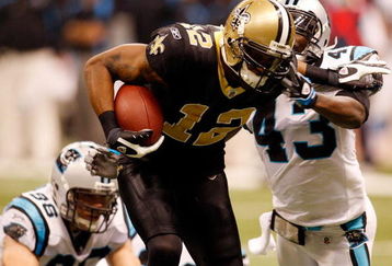 NEW ORLEANS - DECEMBER 28:  Marques Colston #12 of the New Orleans Saints avoids a tackle to score a touchdown around Chris Harris #43 of the Carolina Panthers on December 28, 2008 at the Superdome in New Orleans, Louisiana.  (Photo by Chris Graythen/Getty Images)