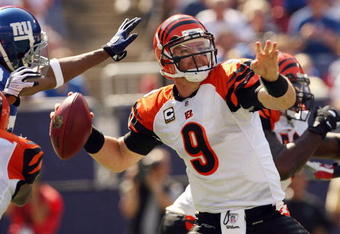 EAST RUTHERFORD, NJ - SEPTEMBER 21:  Carson Palmer #9 of the Cincinnati Bengals looks to pass as he is pressured by the New York Giants defense on September 21, 2008 at Giants Stadium in East Rutherford, New Jersey  (Photo by Elsa/Getty Images)