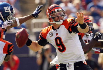 EAST RUTHERFORD, NJ - SEPTEMBER 21:  Carson Palmer #9 of the Cincinnati Bengals looks to pass as he is pressured by the New York Giants defense on September 21, 2008 at Giants Stadium in East Rutherford, New Jersey  (Photo by Elsa/Getty Images)