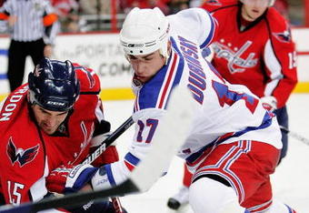 WASHINGTON - APRIL 15: Boyd Gordon #15 of the Washington Capitals battles for the puck on a face off against Brandon Dubinsky #17 of the New York Rangers during Game One of the Eastern Conference Quarterfinals of the 2009 NHL Stanley Cup Playoffs on April 15, 2009 at the Verizon Center in Washington, DC.  (Photo by Len Redkoles/Getty Images)