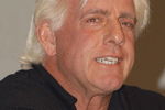 GARDEN CITY, NY - MARCH 3:  World Wrestling Entertainment (WWE) professional wrestler Ric Flair speaks on a panel during the 'Professor For A Day' event at Nassau Community College March 3, 2003 in Garden City, New York. Flair acted as an assistant professor to WWE CEO Linda McMahon, who lectured a group of sports marketing majors on the marketing and promotional strategies that have made the WWE a long-term success.  (Photo By Steven Henry/Getty Images)
