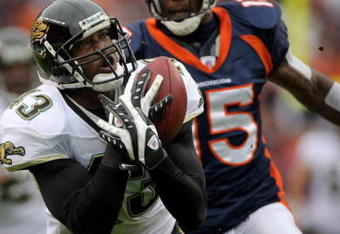 DENVER - OCTOBER 12:  Safety Gerald Sensabaugh #43 of the Jacksonville Jaguars makes an interception on a pass intended for wide receiver Brandon Marshall #15 of the Denver Broncos from Jay Cutler during NFL action on October 12, 2008 at Invesco Field at Mile High in Denver, Colorado.  (Photo by Doug Pensinger/Getty Images)
