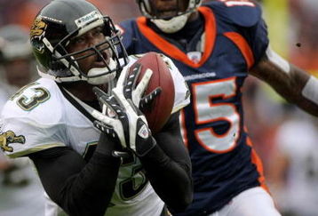 DENVER - OCTOBER 12:  Safety Gerald Sensabaugh #43 of the Jacksonville Jaguars makes an interception on a pass intended for wide receiver Brandon Marshall #15 of the Denver Broncos from Jay Cutler during NFL action on October 12, 2008 at Invesco Field at Mile High in Denver, Colorado.  (Photo by Doug Pensinger/Getty Images)